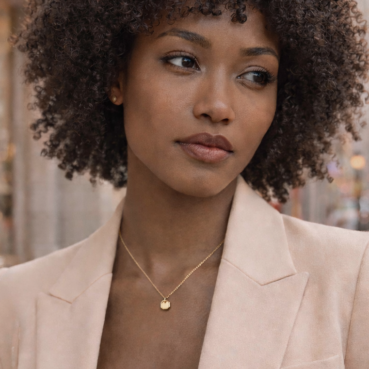 Woman in a beige blazer standing on a city street