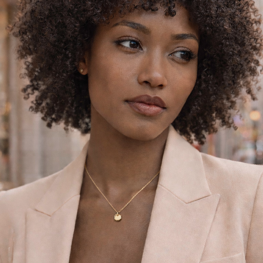 Woman in a beige blazer standing on a city street